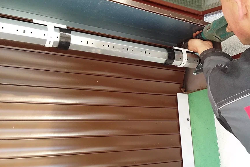 man repairing shutter