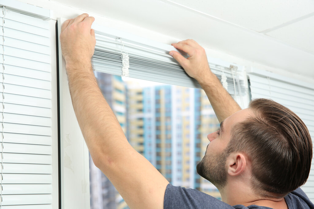 man repairing shutter