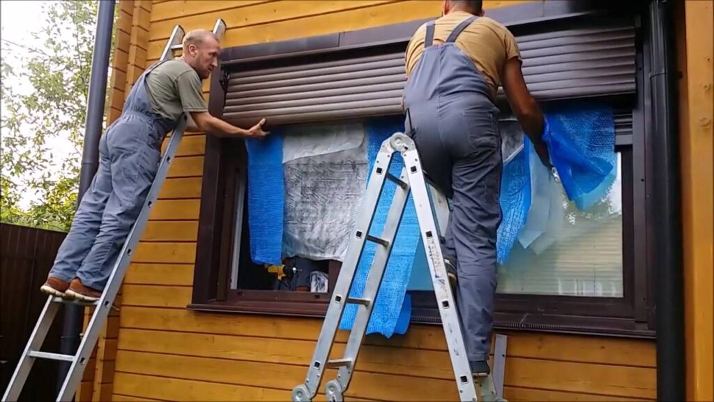 man repairing shutter